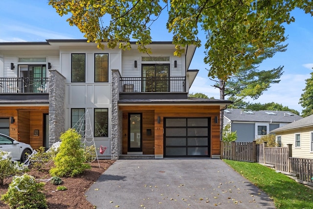 view of front of home with a balcony and a garage