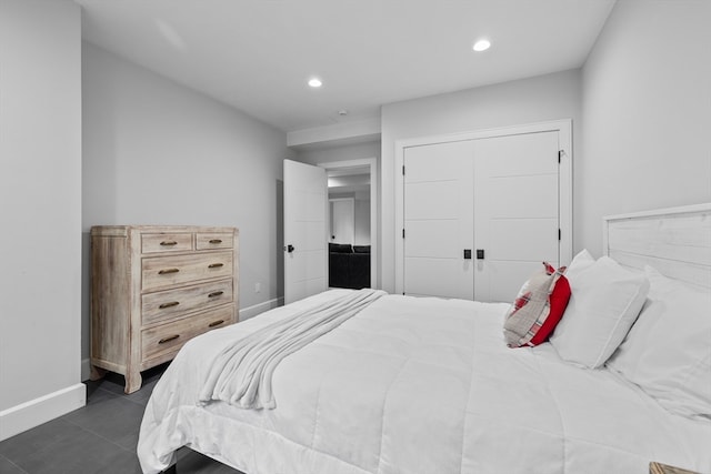 bedroom featuring a closet and dark tile patterned floors