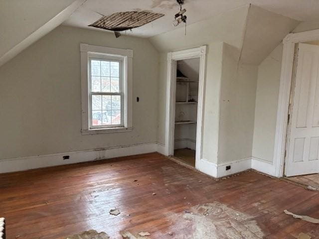 bonus room featuring wood-type flooring and lofted ceiling