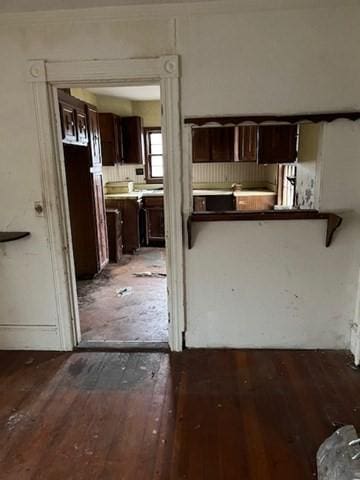 kitchen with dark brown cabinets and hardwood / wood-style flooring