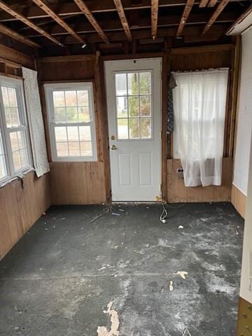 miscellaneous room with a wealth of natural light and wooden walls