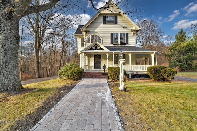 view of front of property with a porch and a front yard