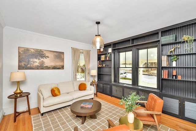 living room with hardwood / wood-style flooring and crown molding