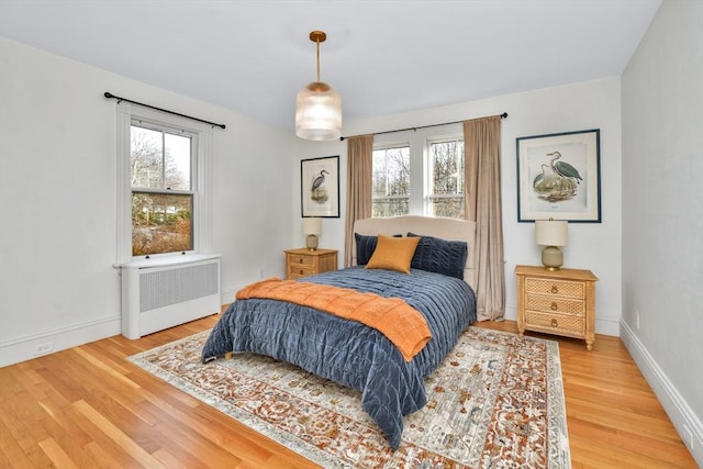 bedroom with radiator and wood-type flooring