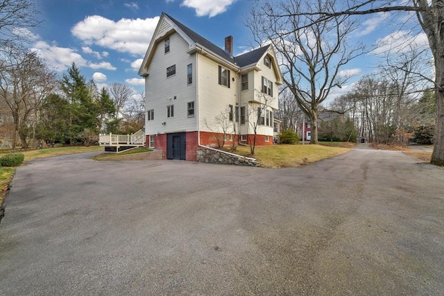 view of property exterior with a lawn