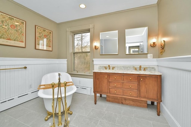 bathroom featuring a bathing tub, tile patterned flooring, crown molding, and a baseboard radiator