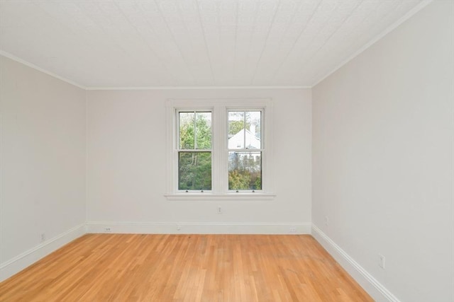 empty room featuring crown molding and light hardwood / wood-style flooring