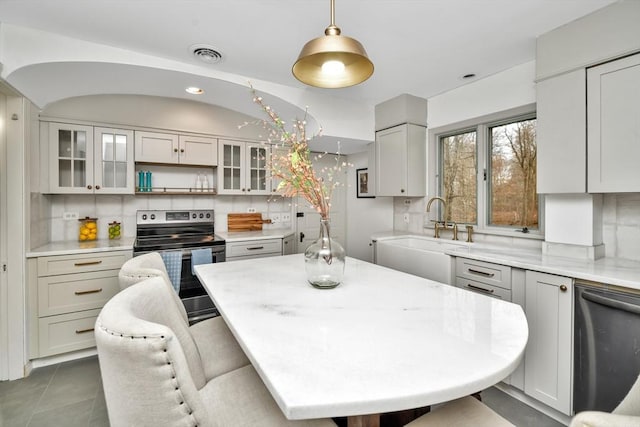 dining space featuring dark tile patterned flooring and sink