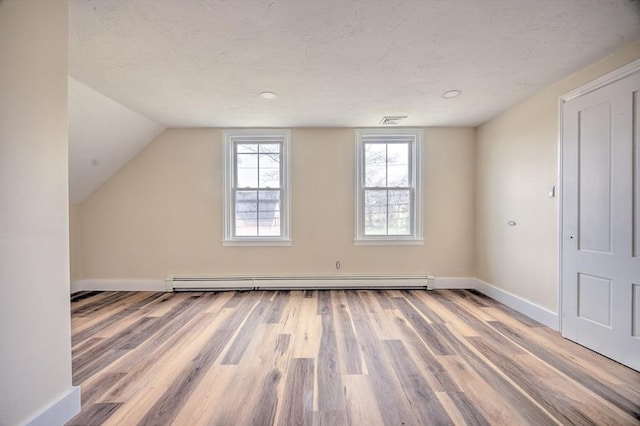 6 Nemasket St, Middleboro, MA 02346 - bonus room featuring visible vents, a baseboard heating unit, wood finished floors, and a textured ceiling