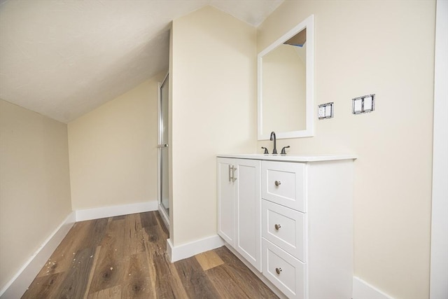 6 Nemasket St, Middleboro, MA 02346 - bathroom featuring vanity, wood finished floors, lofted ceiling, a stall shower, and baseboards