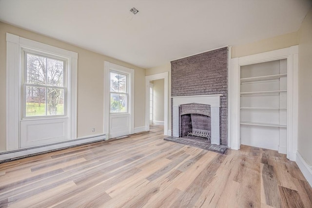 6 Nemasket St, Middleboro, MA 02346 - unfurnished living room featuring a baseboard radiator, wood finished floors, a fireplace, and baseboards