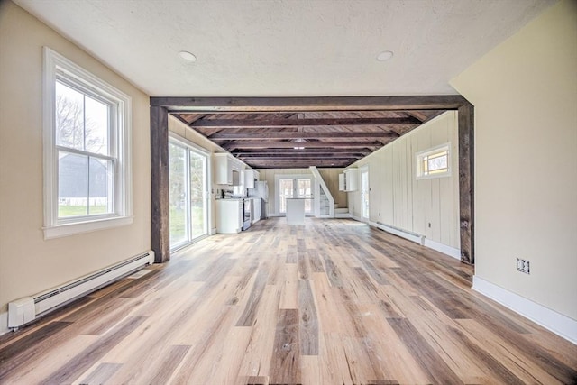 6 Nemasket St, Middleboro, MA 02346 - unfurnished living room featuring light wood finished floors, baseboard heating, a baseboard heating unit, and beam ceiling