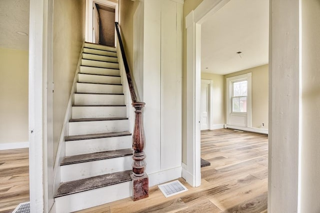 6 Nemasket St, Middleboro, MA 02346 - staircase featuring wood finished floors, baseboards, and visible vents