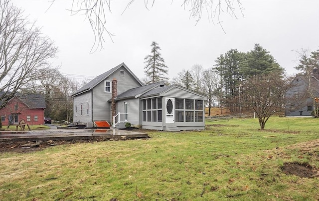 6 Nemasket St, Middleboro, MA 02346 - rear view of property with a yard and a sunroom