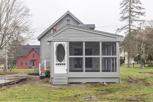6 Nemasket St, Middleboro, MA 02346 - back of property with a sunroom and a lawn