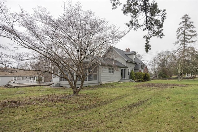 6 Nemasket St, Middleboro, MA 02346 - view of side of property with a wooden deck, a sunroom, a lawn, and a chimney