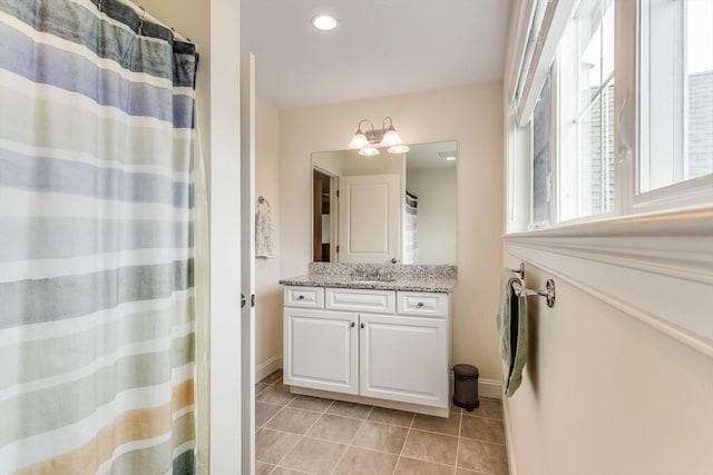 bathroom featuring vanity, tile patterned floors, and walk in shower