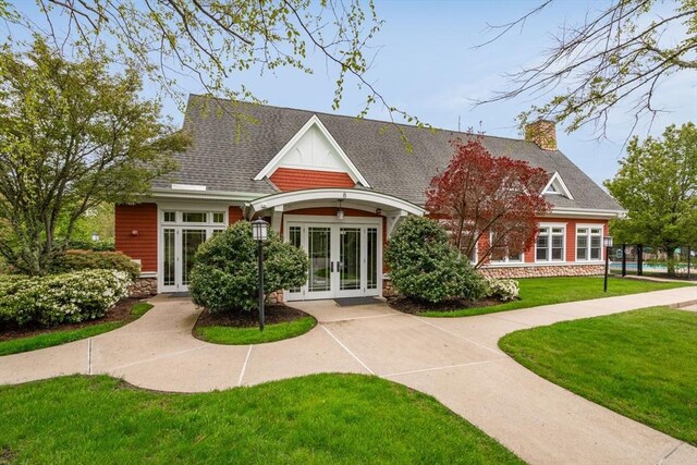 view of front of home featuring french doors and a front yard