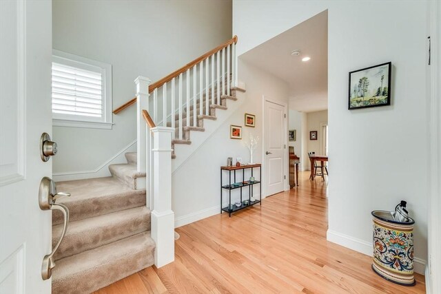 stairway with hardwood / wood-style floors