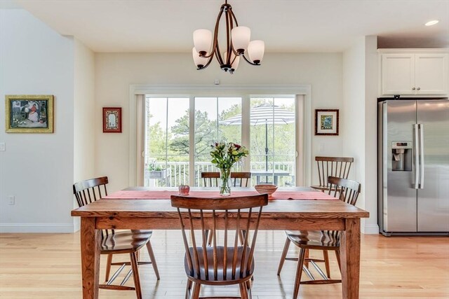 dining room featuring light hardwood / wood-style flooring and a chandelier