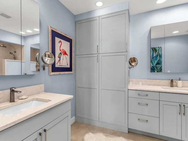 bathroom with tile patterned flooring, vanity, and walk in shower