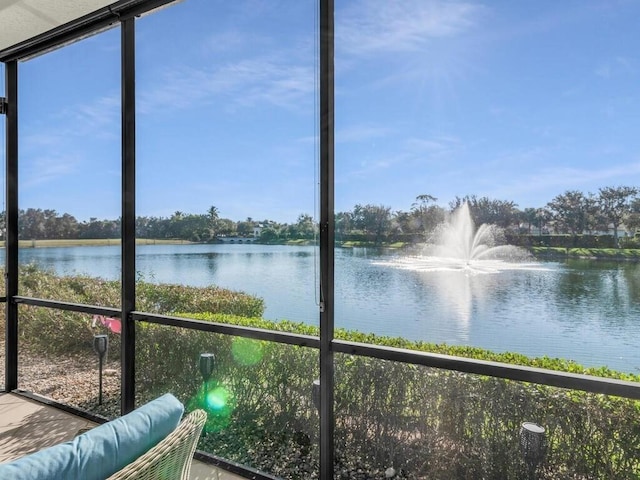 unfurnished sunroom with a water view