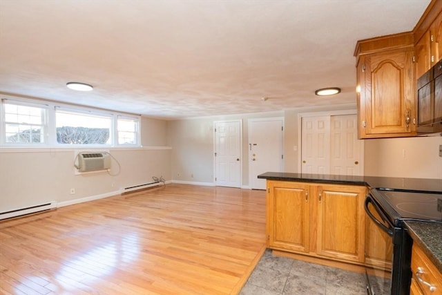 kitchen with black appliances, a baseboard heating unit, light hardwood / wood-style floors, kitchen peninsula, and a wall unit AC