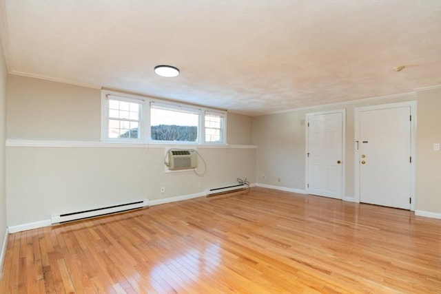 spare room with baseboard heating, crown molding, a wall unit AC, and light wood-type flooring