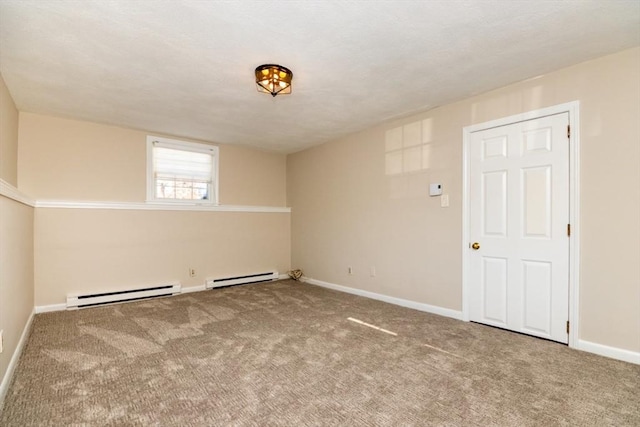 carpeted spare room with baseboard heating