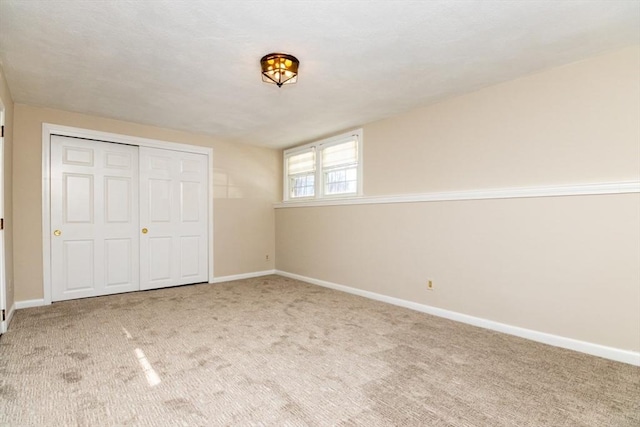 unfurnished bedroom with a closet and carpet