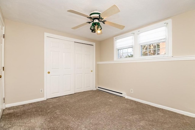 unfurnished bedroom with baseboard heating, ceiling fan, carpet floors, and a closet