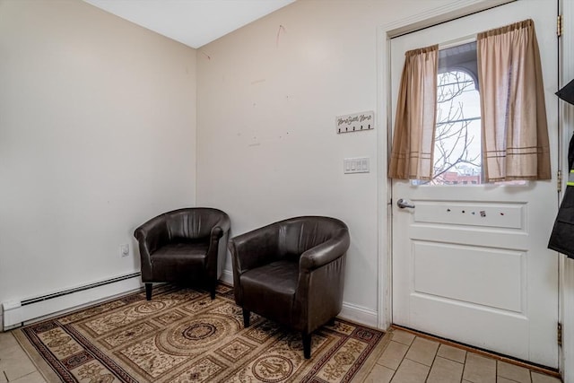 sitting room featuring light tile patterned flooring, baseboard heating, and baseboards