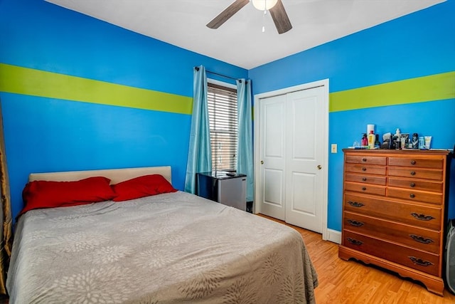 bedroom featuring a closet, ceiling fan, and light wood finished floors