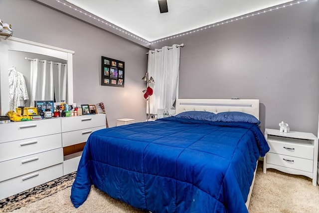 bedroom with a ceiling fan and carpet floors