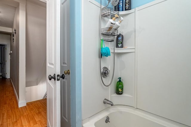 bathroom featuring shower / bathing tub combination and wood finished floors