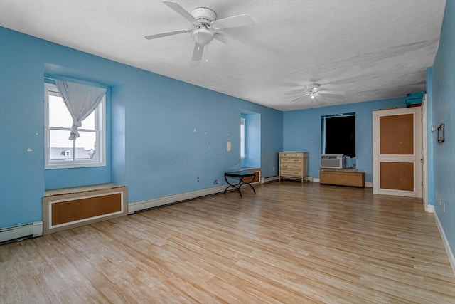 unfurnished room with baseboards, a baseboard heating unit, a ceiling fan, and wood finished floors