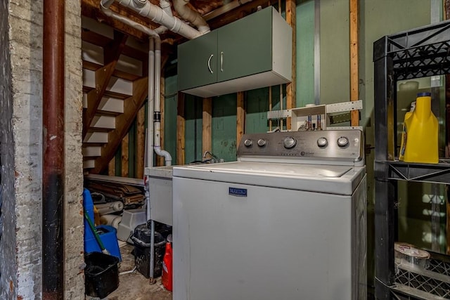 clothes washing area with cabinet space and washer / dryer