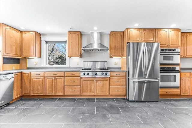 kitchen featuring stainless steel appliances and wall chimney range hood