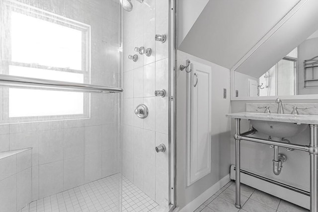 bathroom with tile patterned floors, sink, an enclosed shower, and baseboard heating