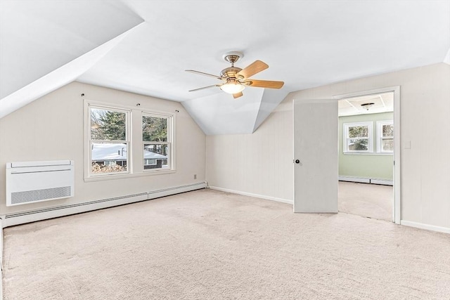 bonus room featuring a baseboard radiator, vaulted ceiling, and a wealth of natural light