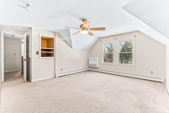 bonus room featuring vaulted ceiling, a wall mounted AC, light colored carpet, and a baseboard radiator