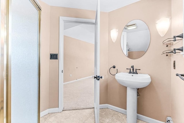 bathroom with sink and a baseboard heating unit