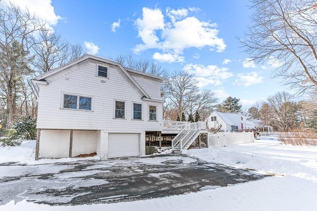 view of front of property featuring a wooden deck and a garage