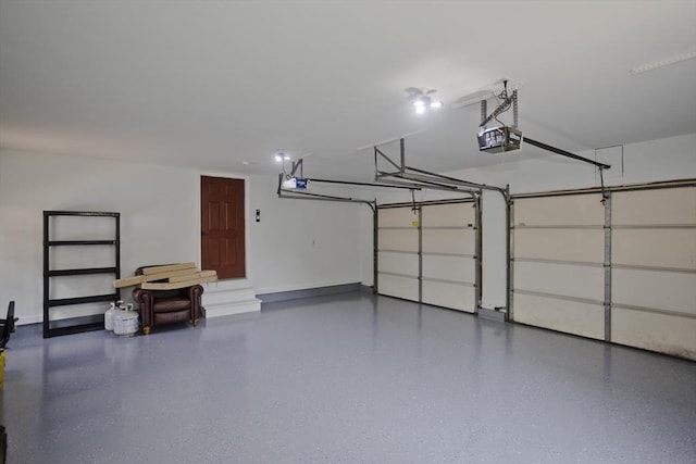 47 Avis Cir, Northampton, MA 01062 - garage featuring a garage door opener and baseboards