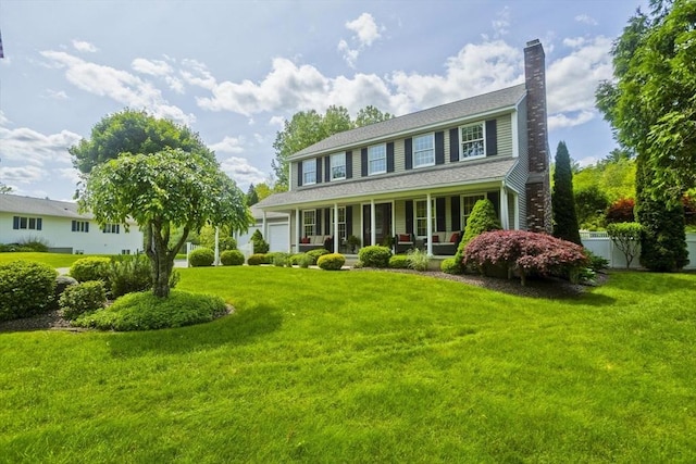 47 Avis Cir, Northampton, MA 01062 - colonial home featuring a chimney, covered porch, and a garage