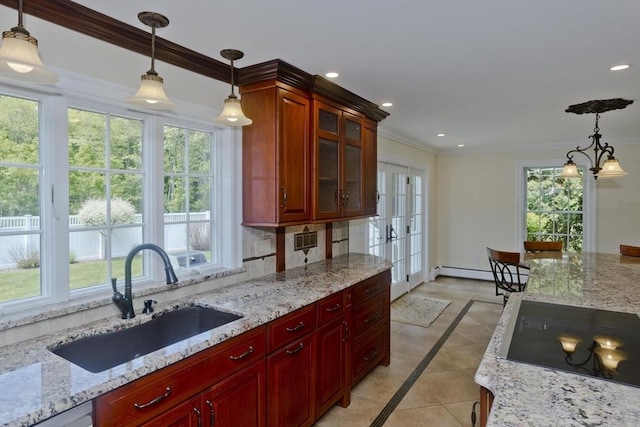 47 Avis Cir, Northampton, MA 01062 - kitchen with a sink, inlaid floor details, black electric cooktop, french doors, and crown molding