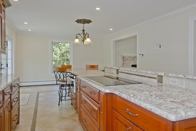 47 Avis Cir, Northampton, MA 01062 - kitchen with inlaid floor details, black electric cooktop, brown cabinets, decorative light fixtures, and light stone countertops