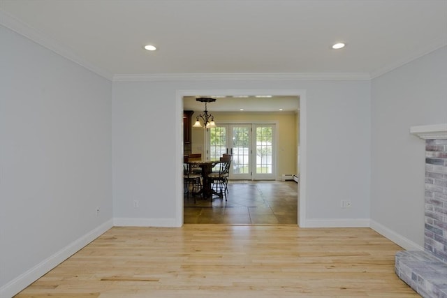 47 Avis Cir, Northampton, MA 01062 - living room featuring wood finished floors, a chandelier, crown molding, baseboards, and a brick fireplace