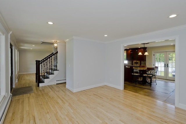47 Avis Cir, Northampton, MA 01062 - spare room with a baseboard heating unit, french doors, stairway, light wood finished floors, and crown molding