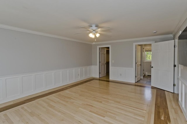 47 Avis Cir, Northampton, MA 01062 - unfurnished room with ceiling fan, light wood-style flooring, crown molding, a baseboard radiator, and wainscoting